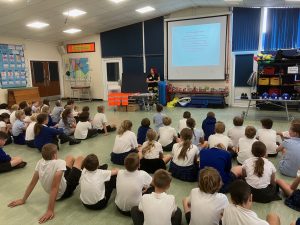 Image description: Sam Uren talking to the children about Civil Engineering.